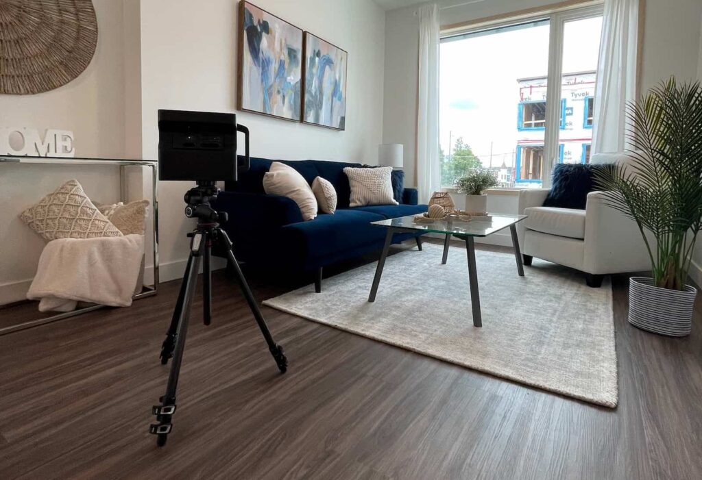 Uma sala de estar está sendo fotografada por uma câmera Matterport para a realização de um tour virtual.