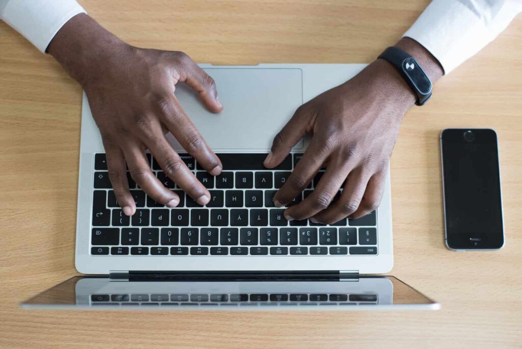 Um homem está mapeando os riscos de segurança de dados em seu notebook.